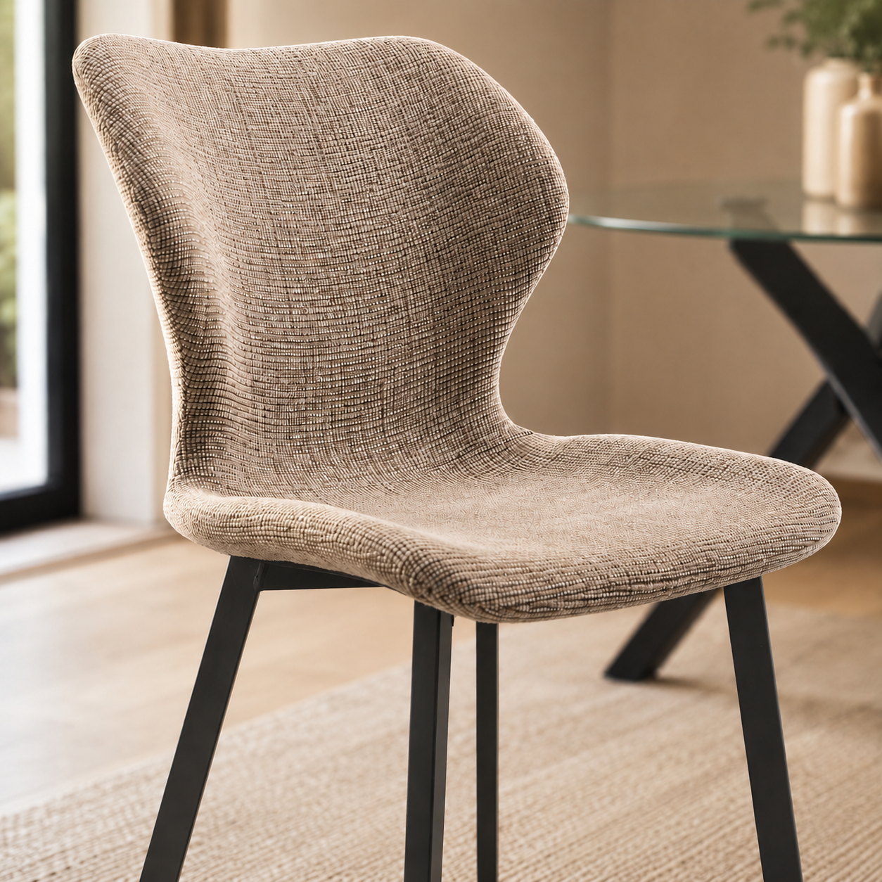 Silla tapizada de diseño moderno con respaldo envolvente y patas metálicas